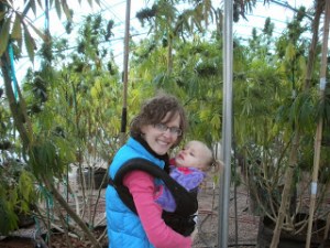 Rachael and Maggie pose with the Realm of Caring's cannabis garden. 