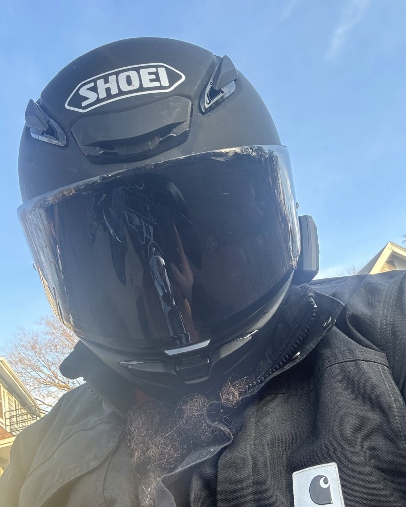 Jason Karimi, publisher of WeedPress, in a tinted motorcycle helmet